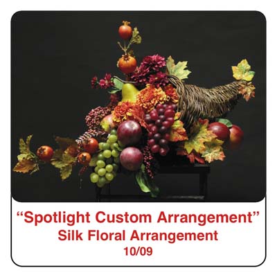October Spotlight Thanksgiving and Fall Cornucopia Arrangement using Fall leaves, grapes, apples, pomegrantes, silk flowers, and silk foliage, and artificial berries